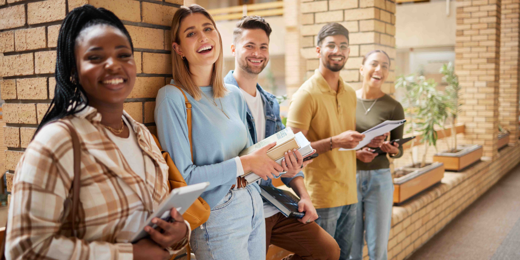 College students on campus with books and devices