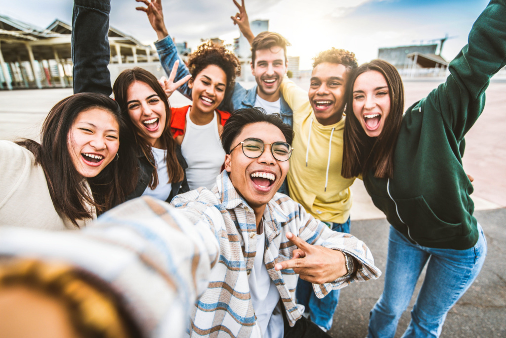 Happy college students taking a selfie together